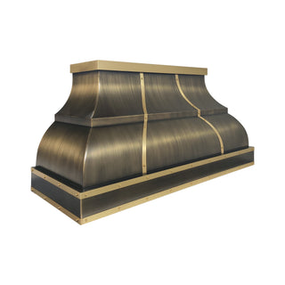 a decorative antique brass range hood or vent cover with brushed brass straps and rivets