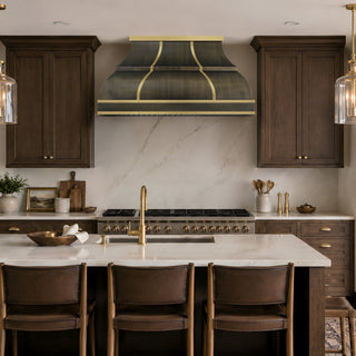 custom kitchen antique brass range hood in a rustic kitchen