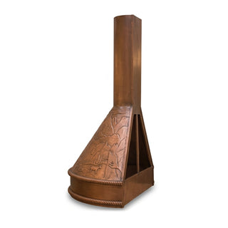 a rustic copper kitchen exhaust hood with a tall chimney stack and an embossed western landscape design on the front panel