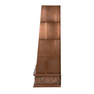side view of square copper range hood with decorative grape vine apron