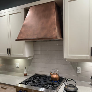 Modern kitchen with copper stove vent hood