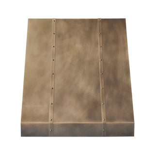 brass kitchen range hood with brass straps and rivets