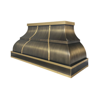 a large industrial-style antique brass range hood with a brushed brass straps