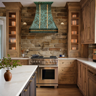 Vintage kitchen with green patina copper range hood.