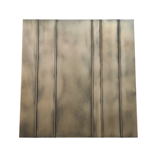 Front view of an aged brass range hood: Rectangular shape with vertical panel detailing.