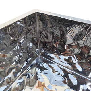 Close-up of a decorative polished stainless steel sink