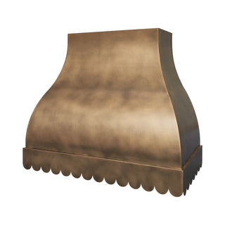 a scalloped-pattern brass range hood