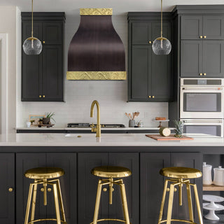 Modern kitchen with black cabinets, SINDA handmade antique copper kitchen vent hood.