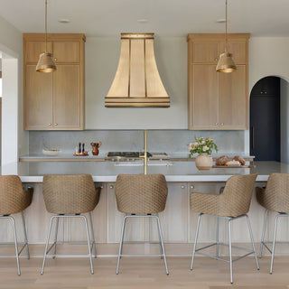 Modern kitchen with wooden cabinets, a brushed brass kitchen hood.
