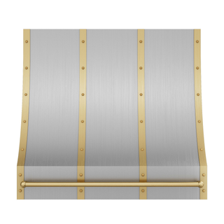 Front view of a brushed stainless steel range hood: Tapers top-to-bottom with curved edges, has brushed brass straps, round rivets and a pot rail.
