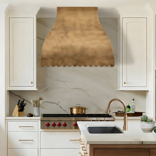 Modern kitchen with a brass range hood