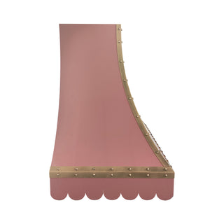 a pink scalloped stainless steel range hood with brass rivets and trim