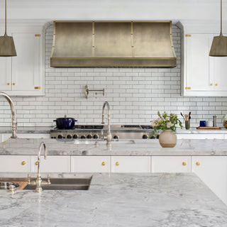 modern kitchen with under cabinet aged brass kitchen hood