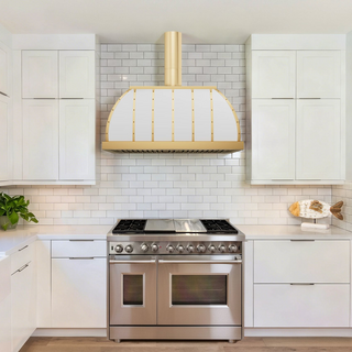 Modern kitchen with white cabinets, white stainless steel stove hood.