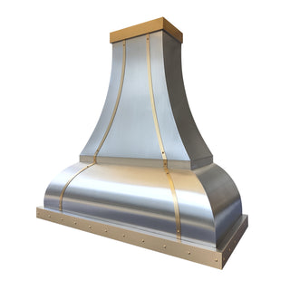Stainless steel range hood with gold accents on a white background