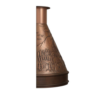 a copper range hood featuring a bear and forest scene with mountains and pine trees