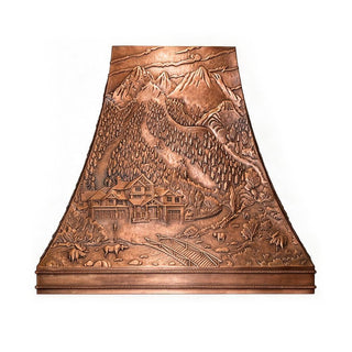 Hand‑hammered solid copper range hood with full‑body 3D forest ranch mountain relief carving, antique copper finish, tapered trapezoid shape