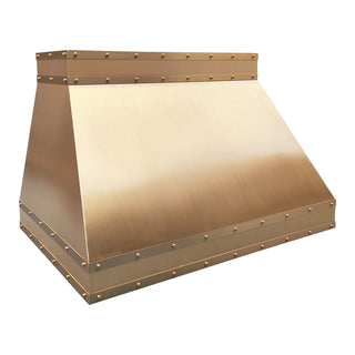 modern kitchen brushed brass range hood with brass straps and round rivets