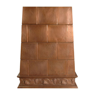 Handcrafted copper range hood with textured panels and grape vine apron